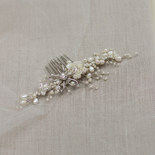 Explore unique handmade bridal hair accessories at our online boutique in Europe. This beautiful one of a kind pearl hair comb, bridal hair adornment, crystal wedding headpiece feature floral motifs, pearl twigs decorated with crystals. Perfect for your occasion or special day. 