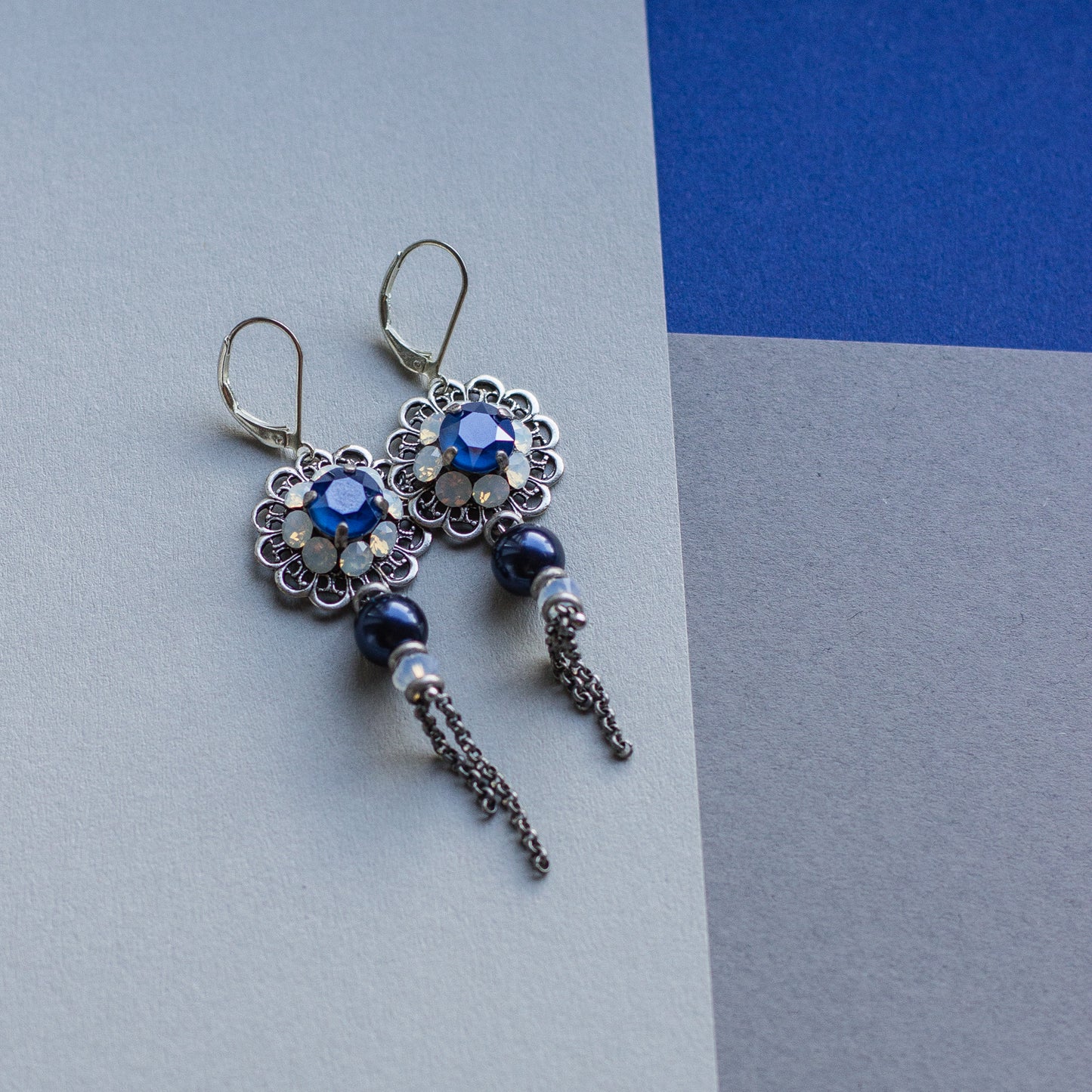 These earrings feature intricate filigree details in royal blue and silver, accented by shiny Swarovski crystals. They make a perfect gift for any occasion.