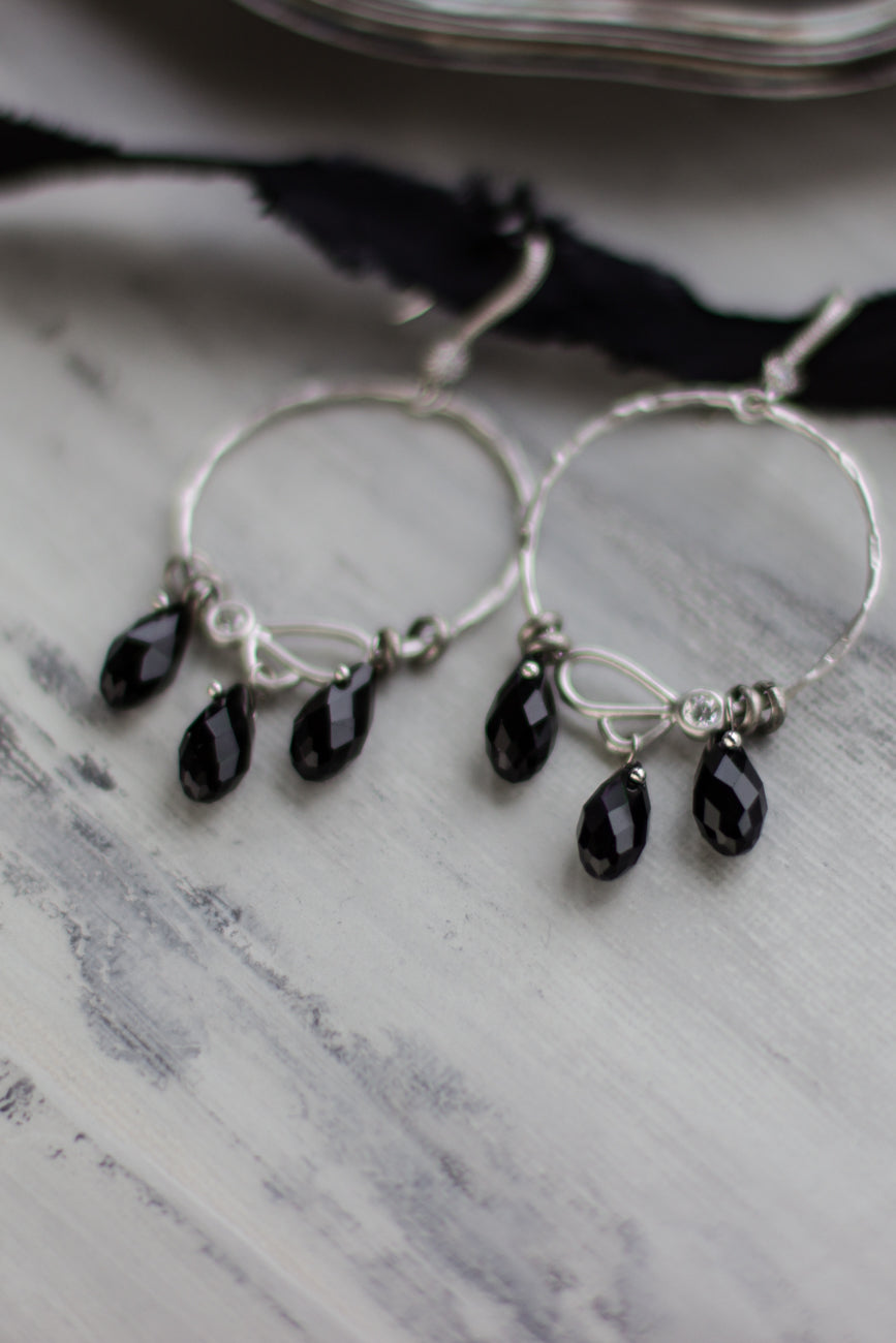 Discover the elegant round hoop earrings with black drop crystals, perfect for women, teens, and girls. This classic jewelry piece makes an ideal gift.