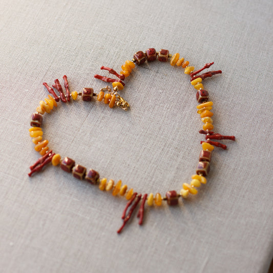  A bright & unique fashion accessory. Amber necklace. Coral necklace. Geometric shape jewelry. Gold, yellow, and red necklace. Fashionable look for summer.