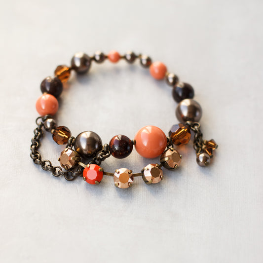 Rustic palette charm bracelet. Stretch bracelet. Pastel orange, brown, rose gold, antiqued brass jewelry.  Pearl bracelet. Crystal accessories.