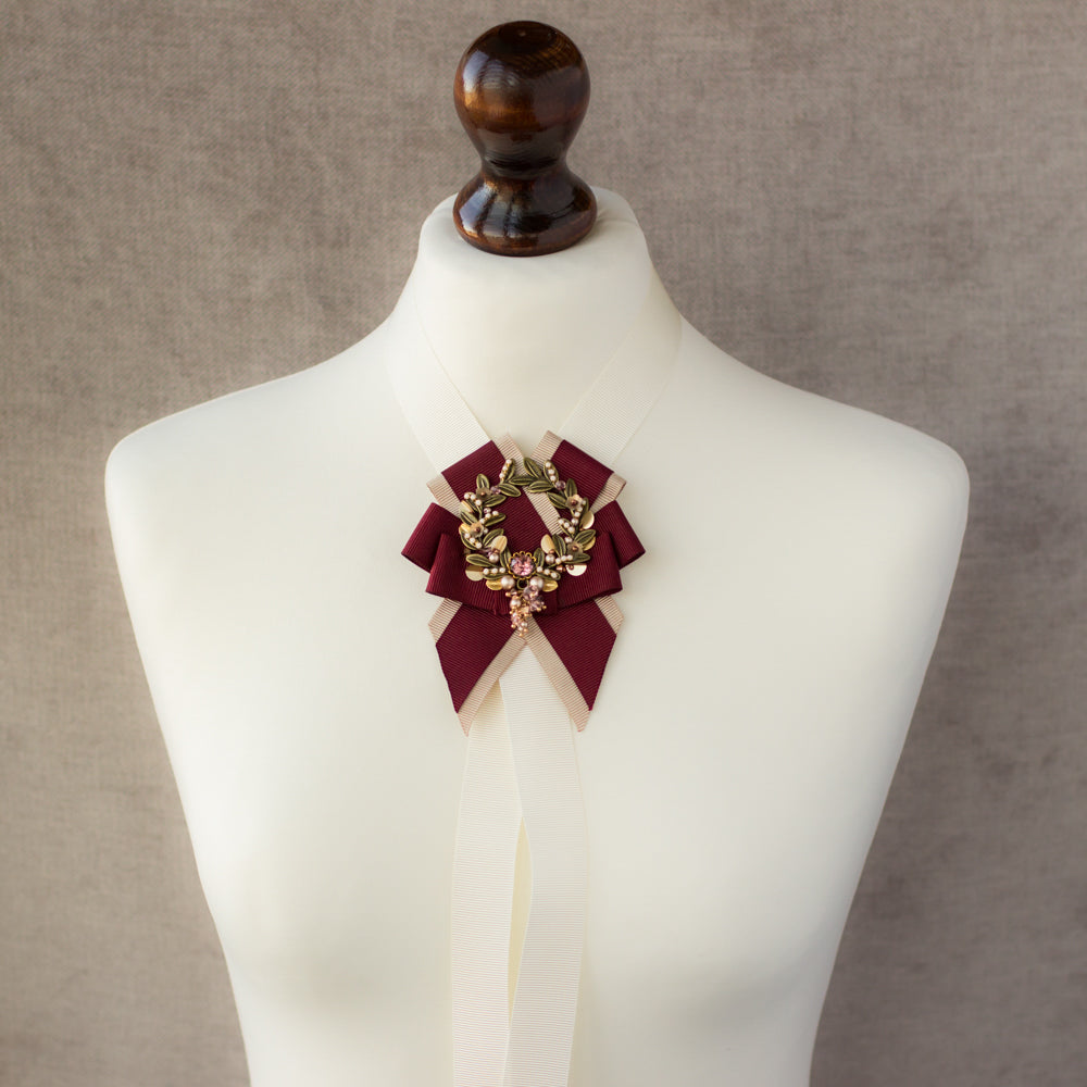Shop this unique handmade leaf wreath brooch featuring burgundy, blush, and beige ribbons. Perfect for any evening occasion, it adds an elegant touch to any outfit and makes for a great gift idea.