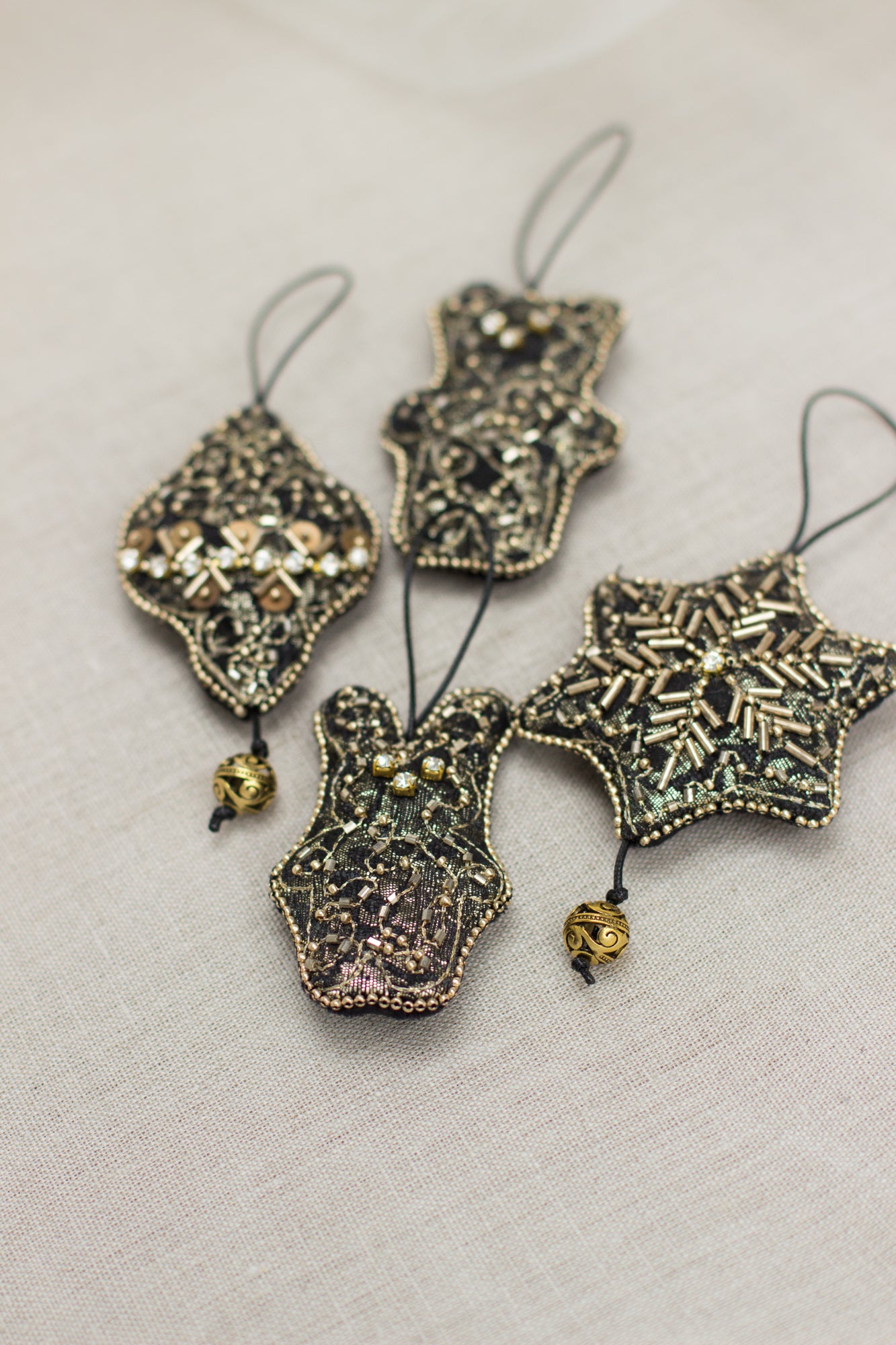 Set of four handmade Christmas ornaments. A gold & black Christmas tree decorations hand embroidered with crystals & seed beads, the back side finished with black velour. Jeweled Christmas ornaments.