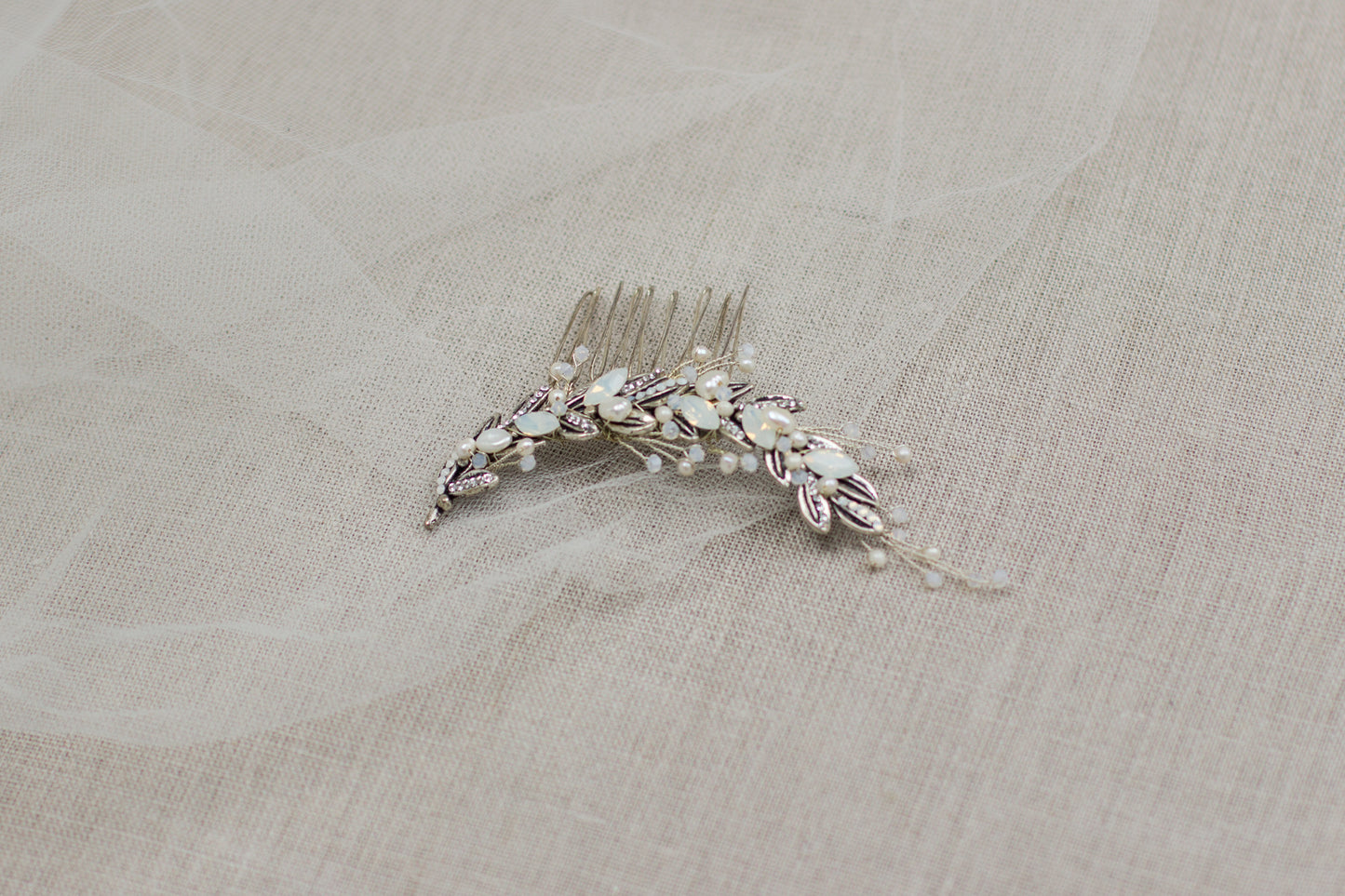 Shop for unique handmade bridal hair accessories in Europe's online wedding boutique. This one-of-a-kind crystal and leaf wedding headpiece, bridal hair comb will make a perfect addition to your wedding day look. White opal hair adornment.