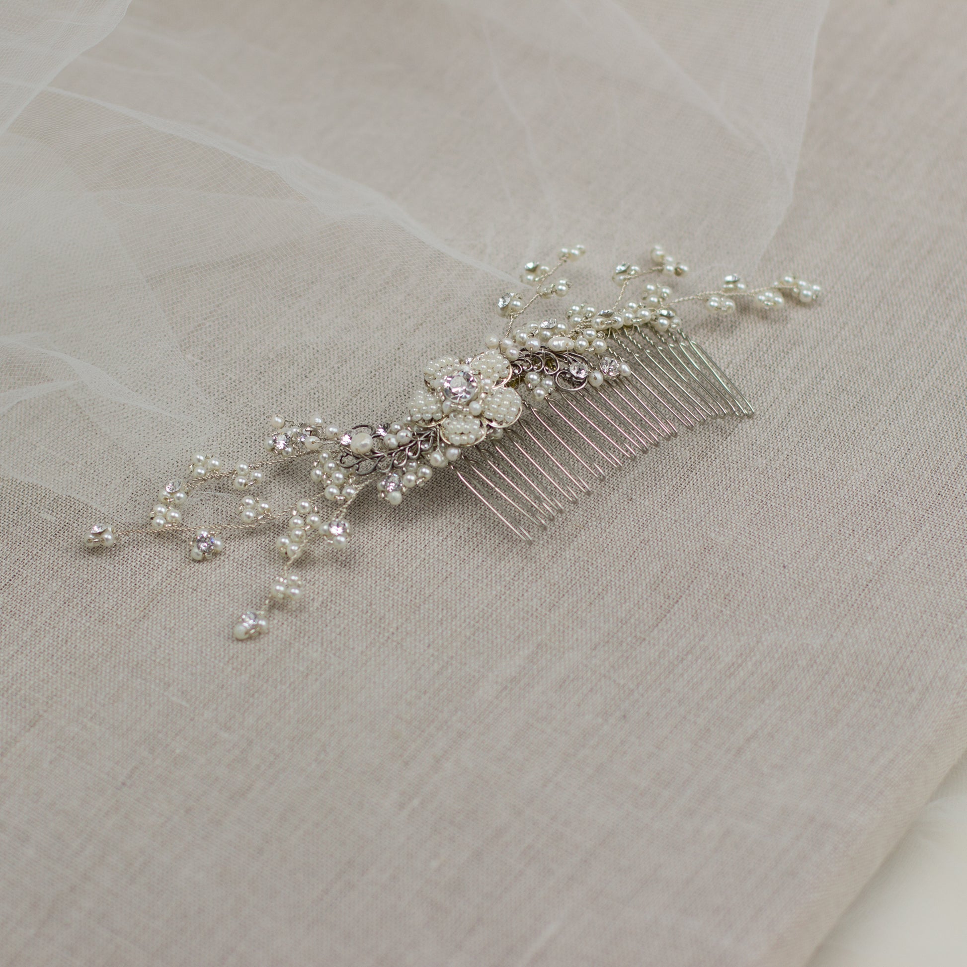 Explore unique handmade bridal hair accessories at our online boutique in Europe. This beautiful one of a kind pearl hair comb, bridal hair adornment, crystal wedding headpiece features floral motifs, pearl twigs decorated with crystals. Perfect for your special day. 