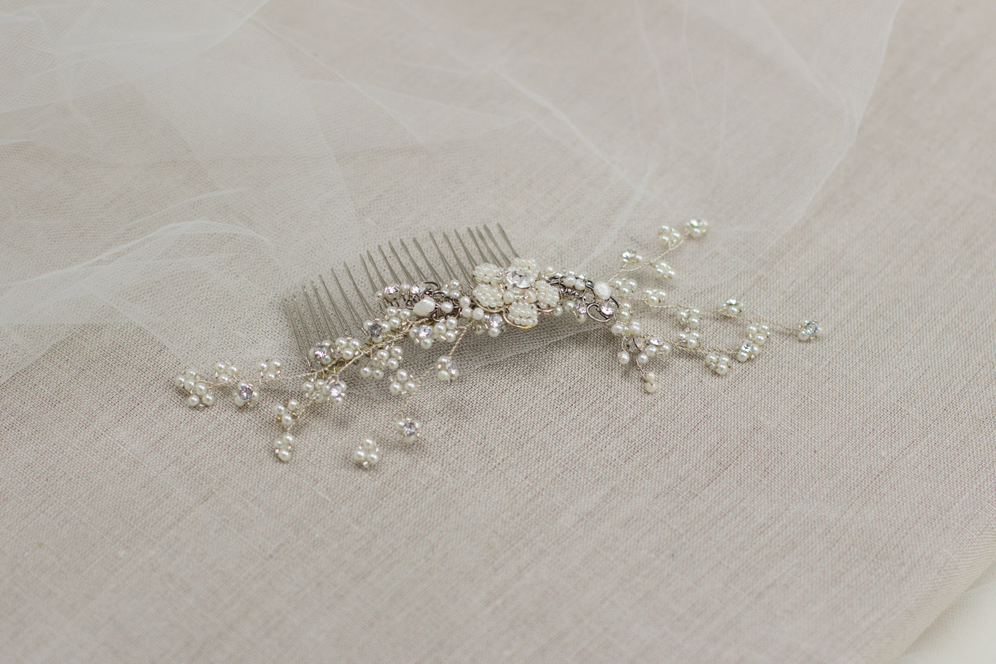 Explore unique handmade bridal hair accessories at our online boutique in Europe. This beautiful one of a kind pearl hair comb, bridal hair adornment, crystal wedding headpiece features floral motifs, pearl twigs decorated with crystals. Perfect for your special day.