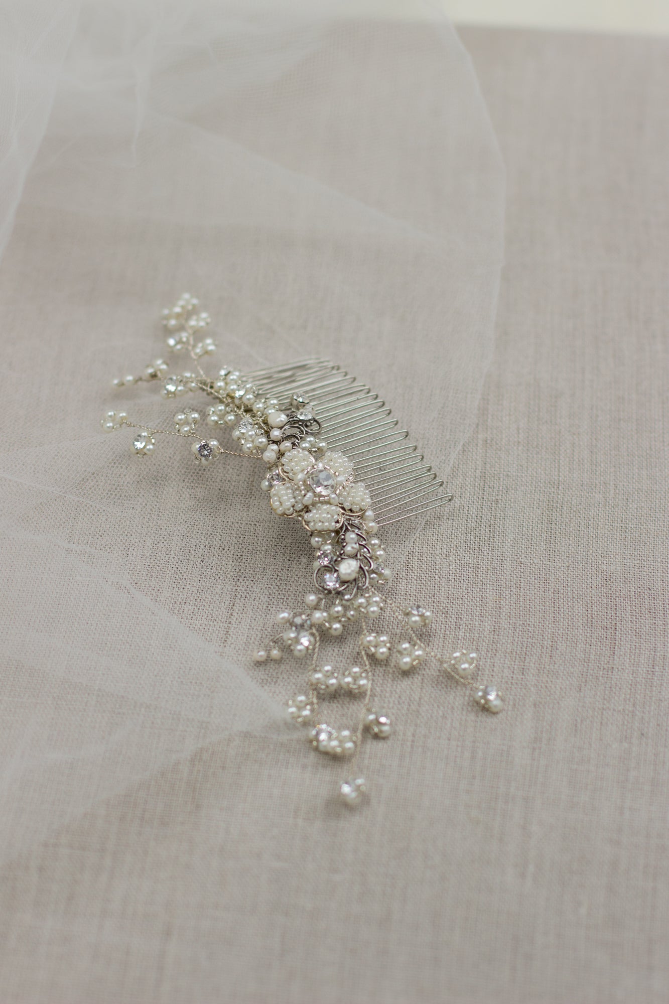Explore unique handmade bridal hair accessories at our online boutique in Europe. This beautiful one of a kind pearl hair comb, bridal hair adornment, crystal wedding headpiece features floral motifs, pearl twigs decorated with crystals. Perfect for your special day.
