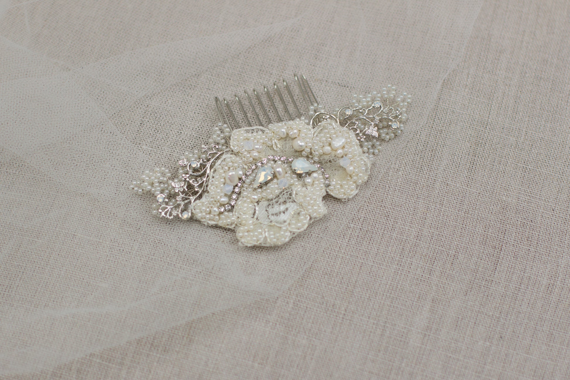 Looking for unique handmade wedding hair accessories? Check out our online bridal boutique in Europe. Stunning lace bridal hair comb made with beautiful pearls and adorned with floral motifs. Lace wedding headpiece, crystal hair comb, hair adornment to complete your bridal look. Shop now and find the perfect wedding hair piece for your special day.