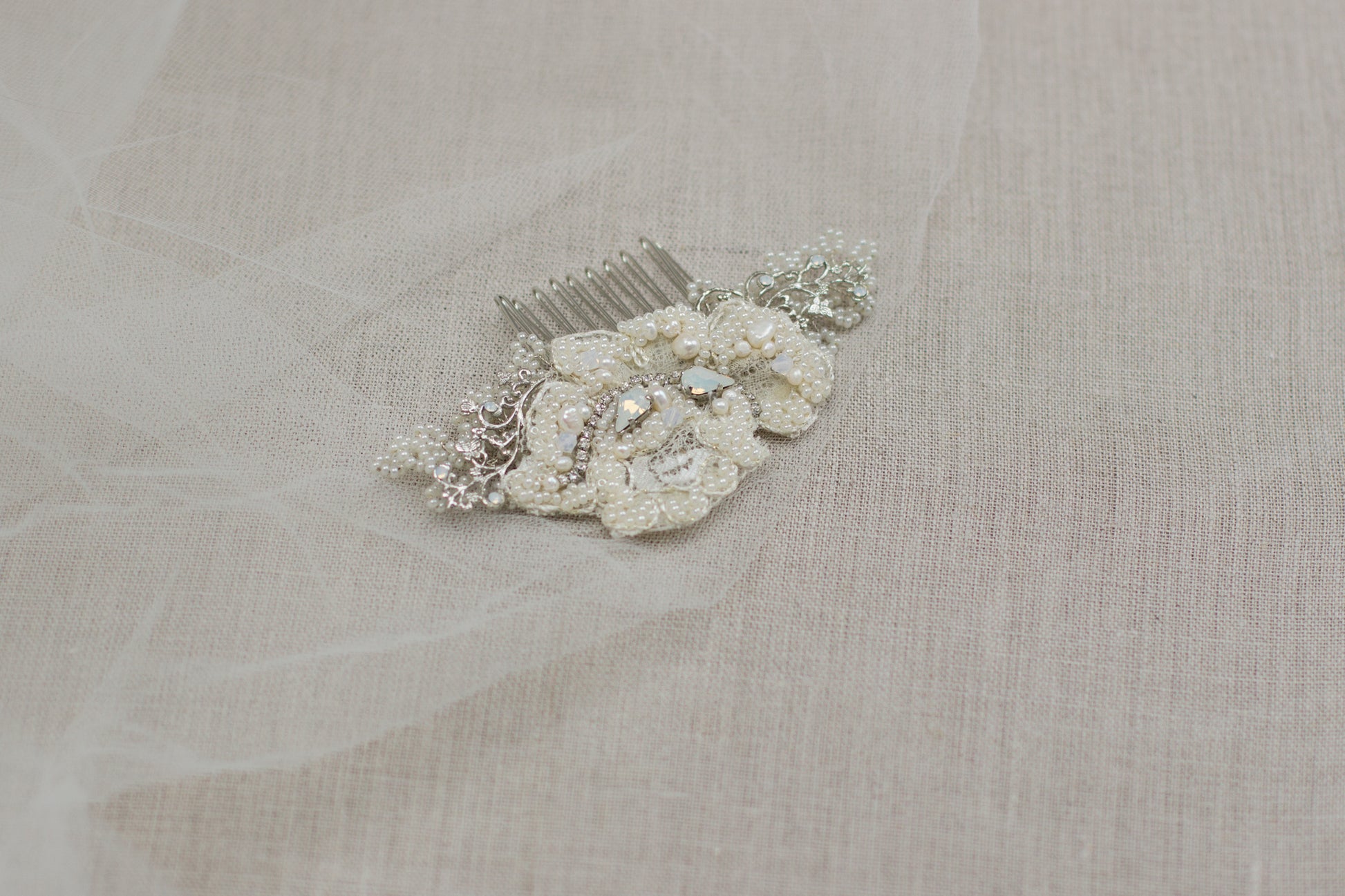 Looking for unique handmade wedding hair accessories? Check out our online bridal boutique in Europe. Stunning lace bridal hair comb made with beautiful pearls and adorned with floral motifs. Lace wedding headpiece, crystal hair comb, hair adornment to complete your bridal look. Shop now and find the perfect wedding hair piece for your special day.