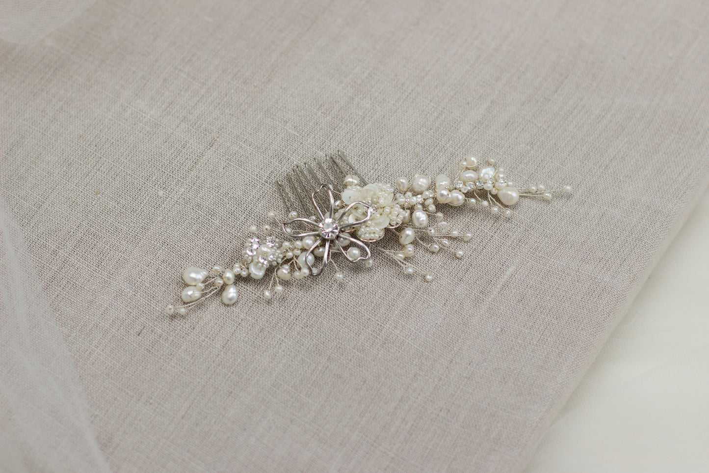 Explore unique handmade bridal hair accessories at our online boutique in Europe. This beautiful one of a kind pearl hair comb, bridal hair adornment, crystal wedding headpiece feature floral motifs, pearl twigs decorated with crystals. Perfect for your special day. 