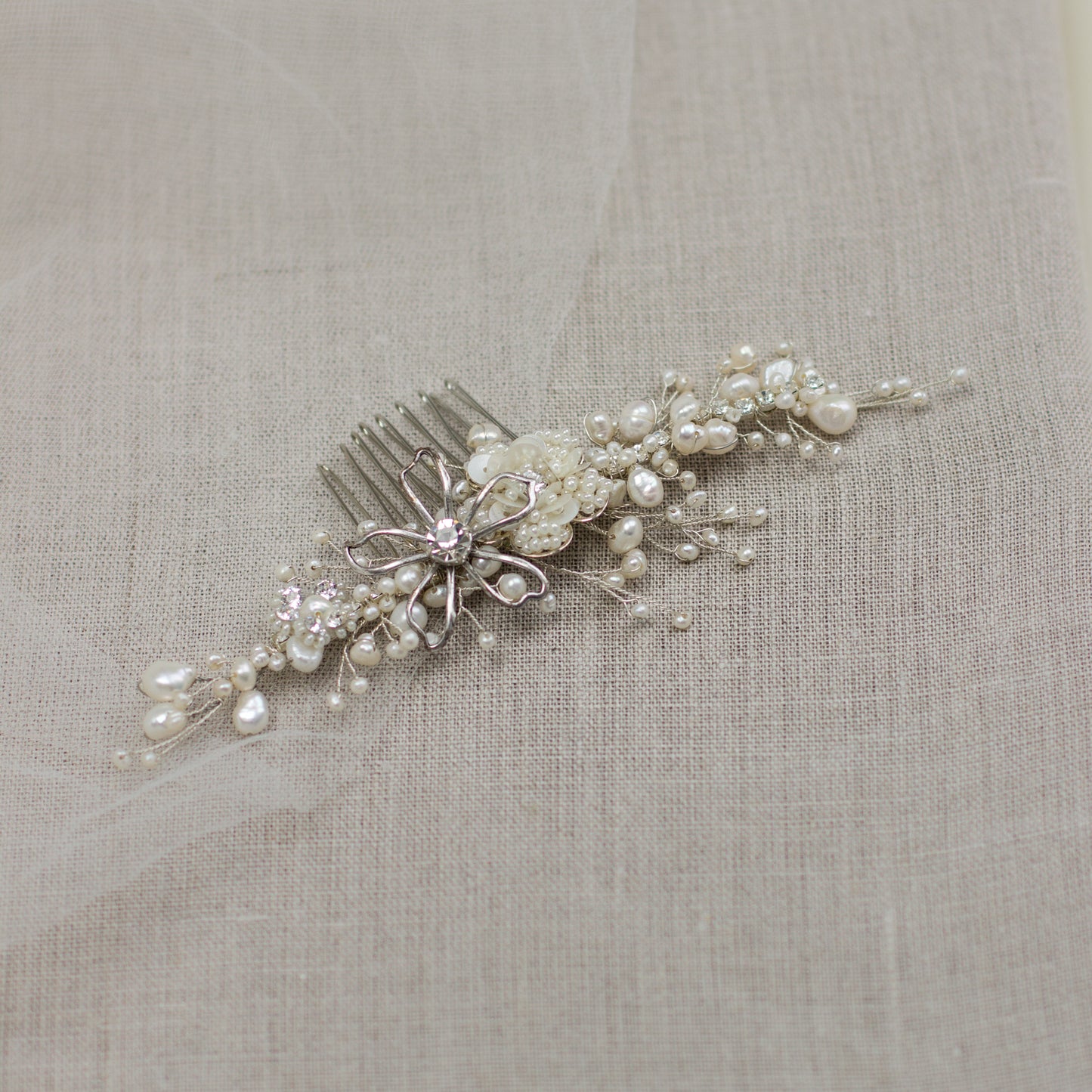 Explore unique handmade bridal hair accessories at our online boutique in Europe. This beautiful one of a kind pearl hair comb, bridal hair adornment, crystal wedding headpiece feature floral motifs, pearl twigs decorated with crystals. Perfect for your occasion or special day. 