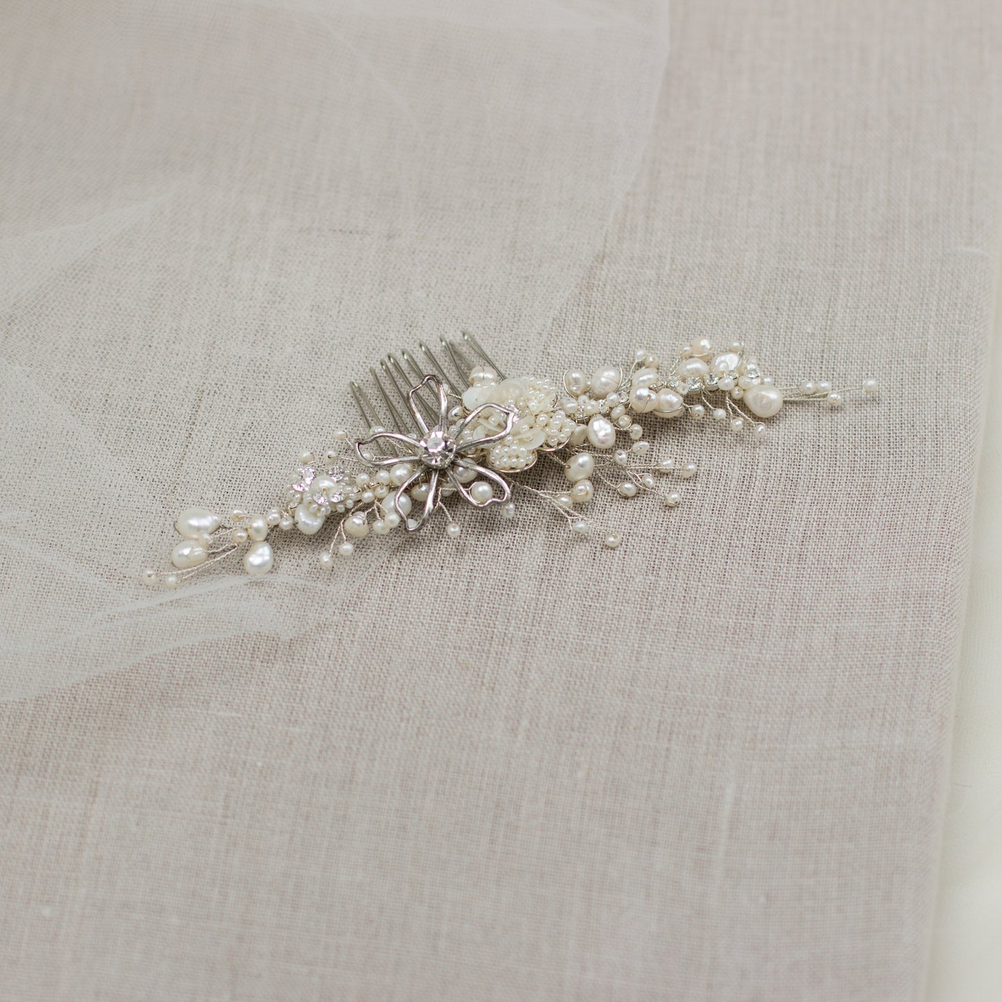 Explore unique handmade bridal hair accessories at our online boutique in Europe. This beautiful one of a kind pearl hair comb, bridal hair adornment, crystal wedding headpiece feature floral motifs, pearl twigs decorated with crystals. Perfect for your occasion or special day.