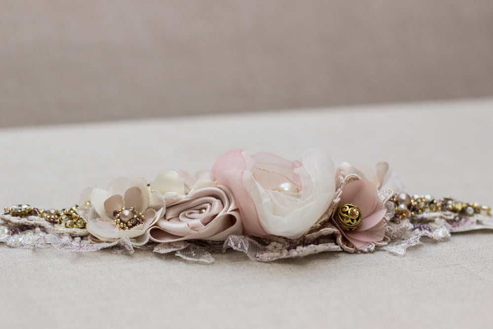 A beautiful handmade wedding dress belt sash that features ivory, blush pink, rose, and mauve hues. Floral design bridal belt sash is perfect for rustic, spring, or summer weddings. Online bridal boutique. One-of-a-kind wedding accessories..