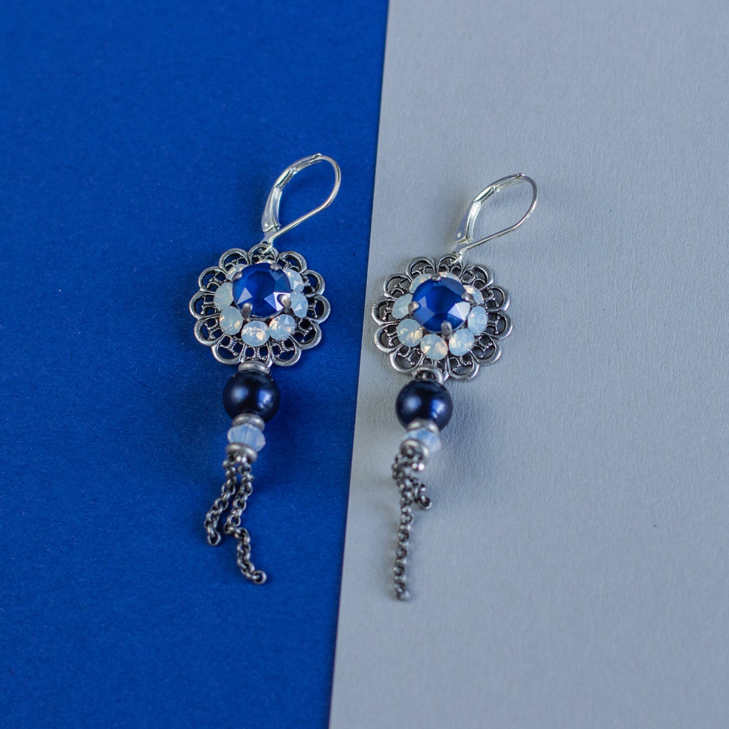 These earrings feature intricate filigree details in royal blue and silver, accented by shiny Swarovski crystals. They make a perfect gift for any occasion.