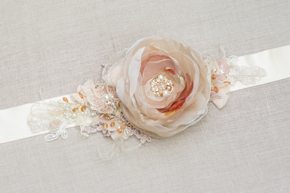 Discover a handmade wedding dress belt sash with cinnamon, rose, orange, beige, and tan floral design, perfect for rustic, spring, or summer weddings. Unique floral bridal belt sash. Online bridal boutique featuring one-of-a-kind wedding accessories. 