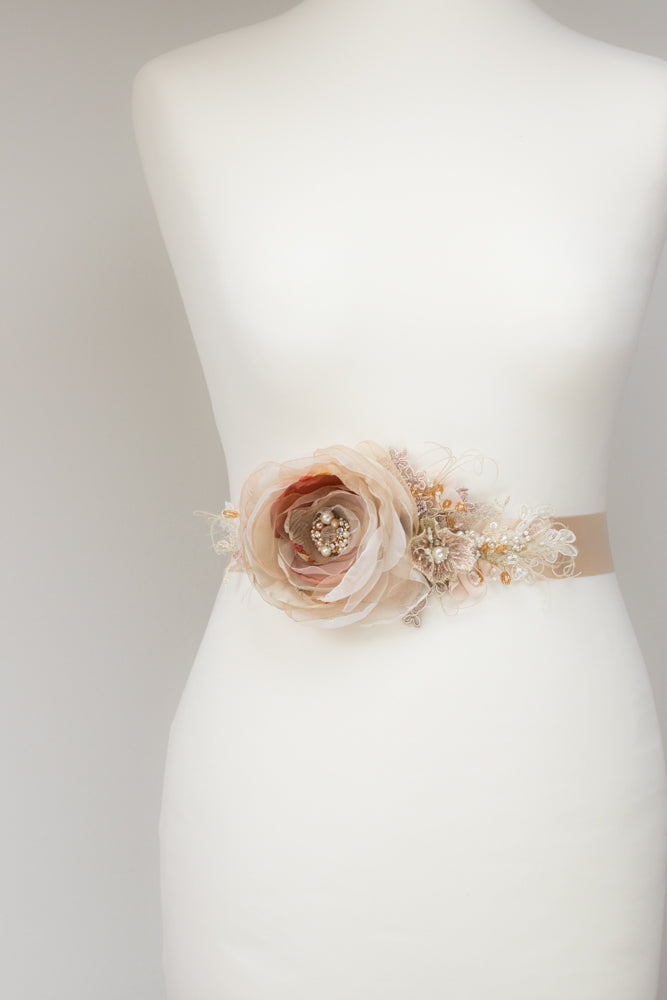 Discover a handmade wedding dress belt sash with cinnamon, rose, orange, beige, and tan floral design, perfect for rustic, spring, or summer weddings. Unique floral bridal belt sash. Online bridal boutique featuring one-of-a-kind wedding accessories. 