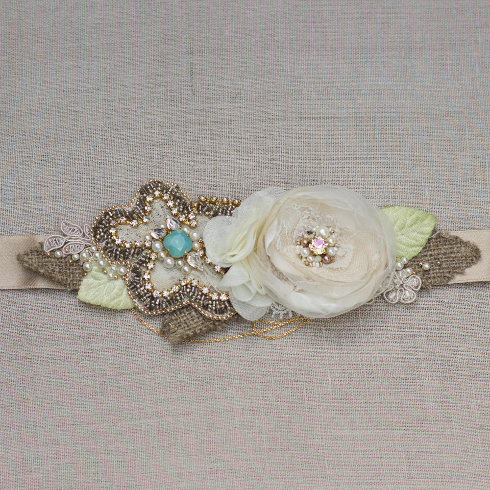A unique handmade wedding dress belt sash. Floral design bridal belt sash features champagne, gold, greenish and burlap perfect for rustic, spring, or summer weddings. Online bridal boutique, which offers one-of-a-kind wedding accessories.