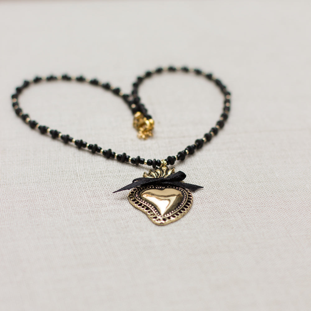 Sacred heart pendant necklace, handmade with black and gold accents. Burning heart necklace. A beautiful gift idea.