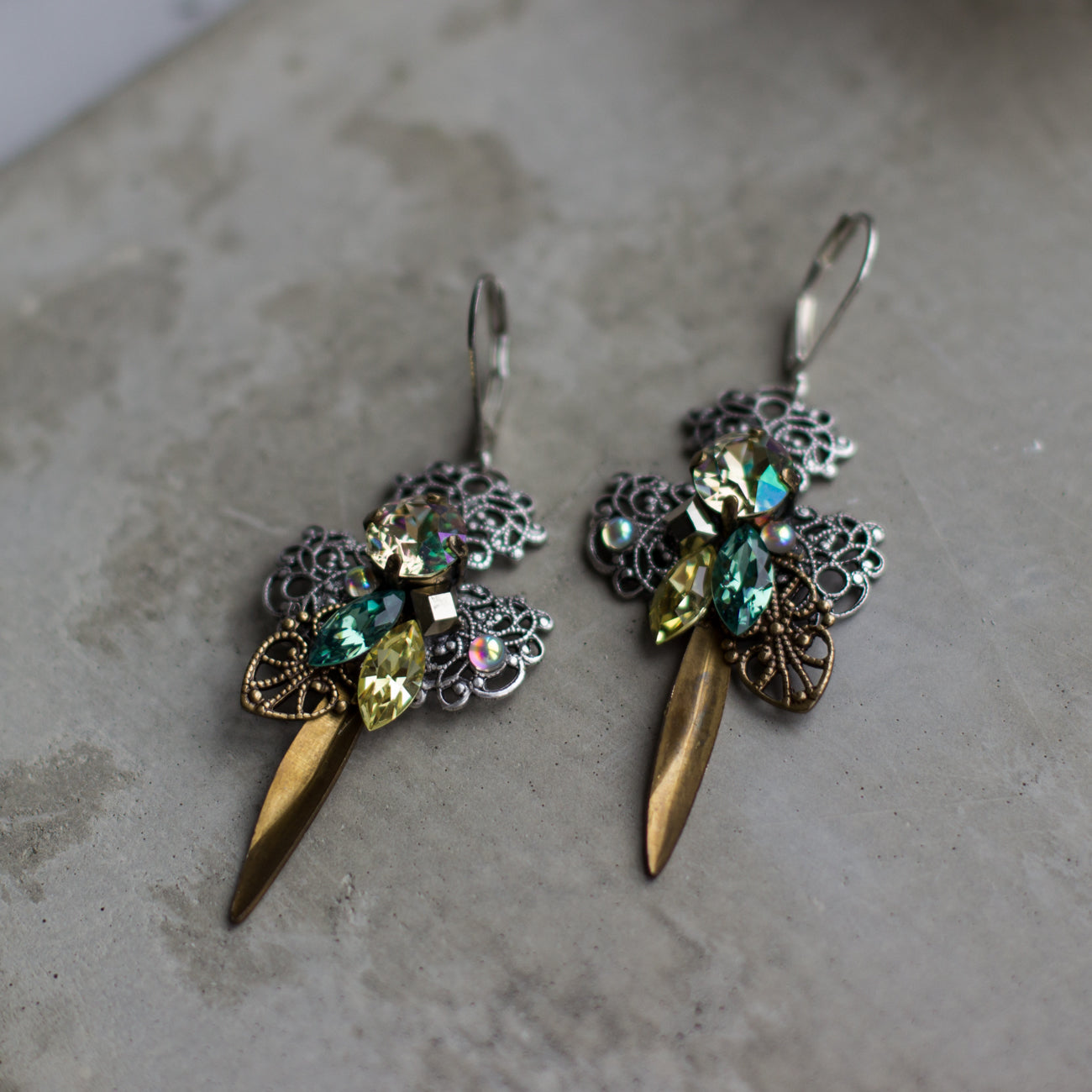 Shop elegant green, yellow, silver, and brass filigree earrings. Perfect for any occasion, these stylish dangle drop earrings add a touch of glamour to any outfit and make a great gift idea. 