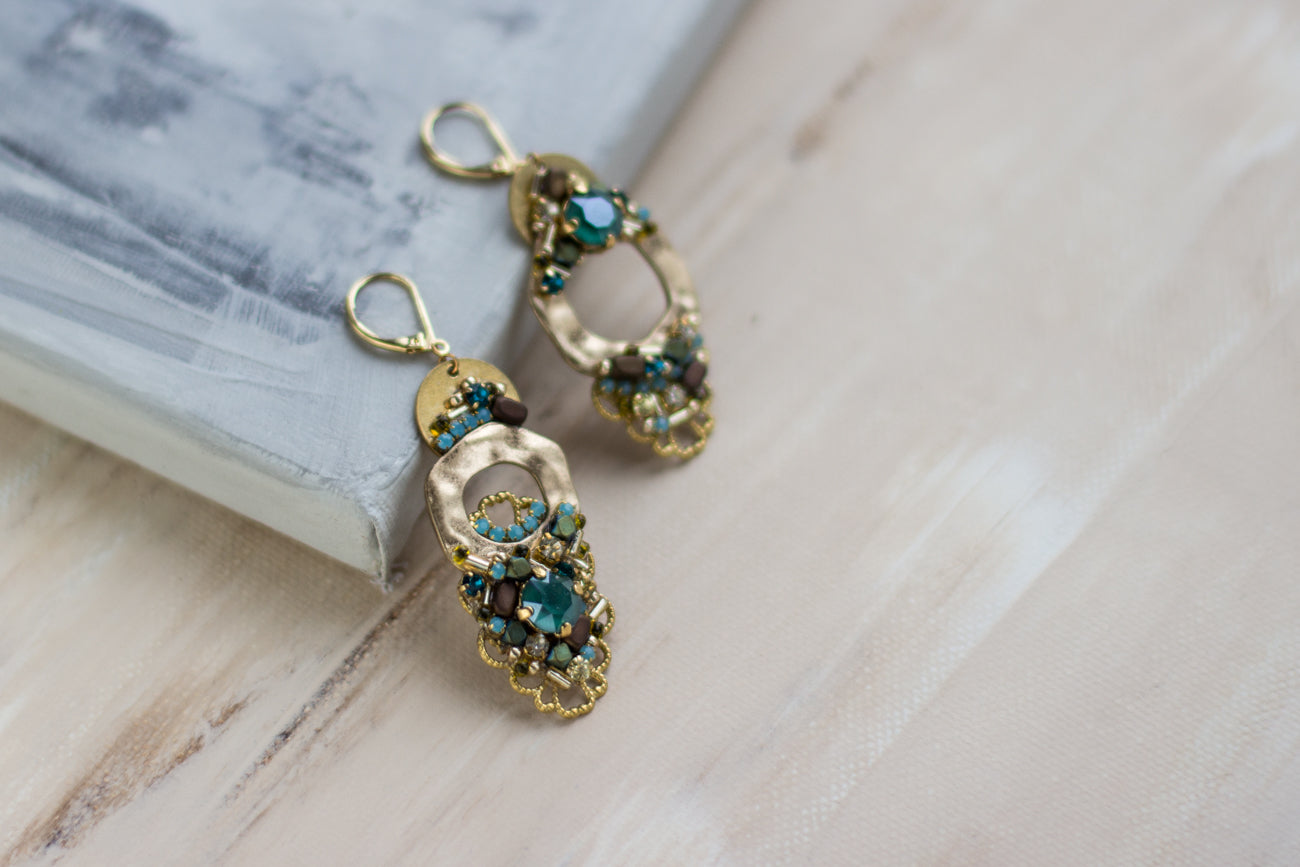 Shop women's jewelry at LeFlowers Bijouterie to discover unique handmade pieces for your wardrobe. Chic asymmetrical earrings. Gold/green evening earrings. Woman jewelry. Crystal earrings. Rhinestone jewelry.