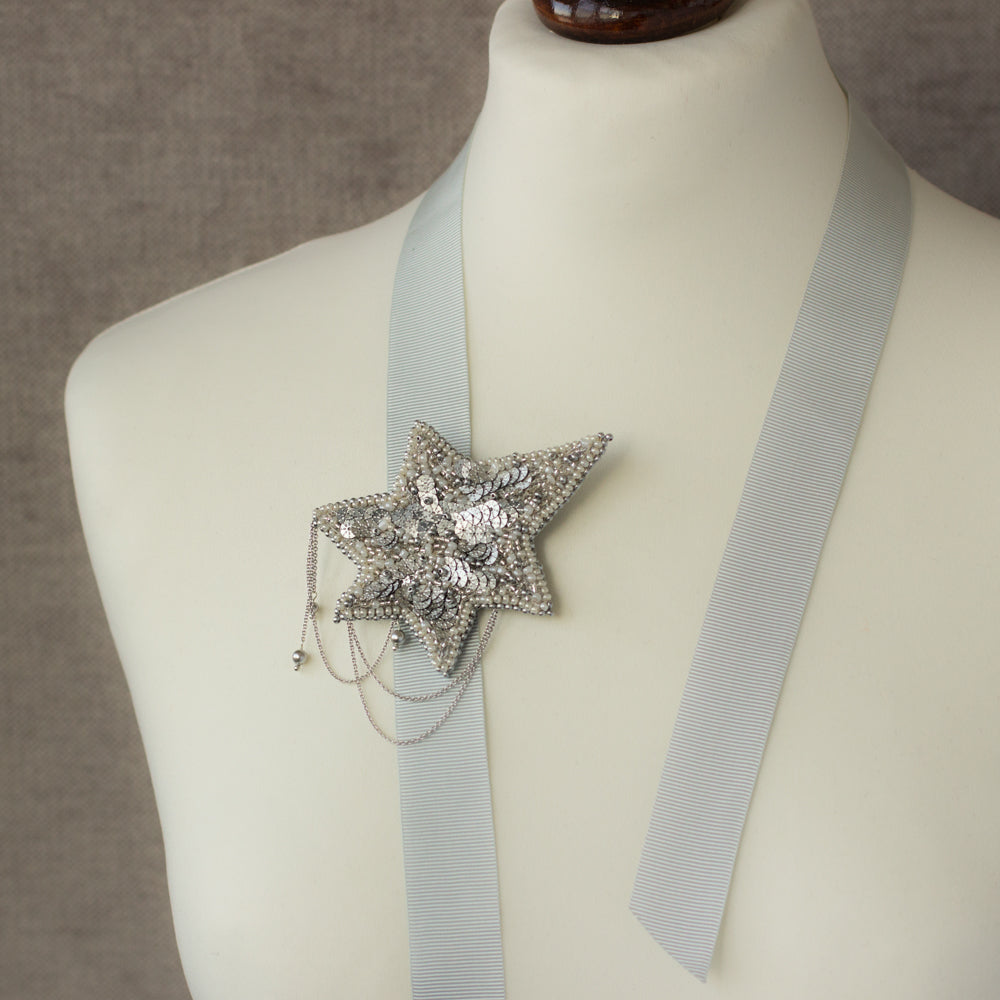 Shop women's jewelry at LeFlowers Bijouterie to discover unique handmade pieces for your wardrobe.  Star brooch. Embroidered jewelry. Gray star brooch. Gray brooch